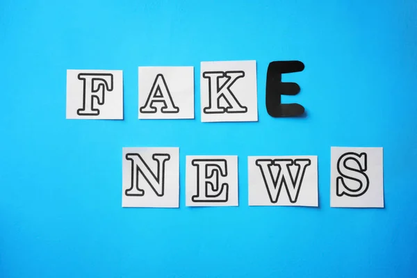 Text FAKE NEWS made of with letters on color background — Stock Photo, Image