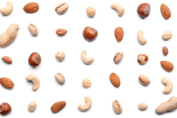 Different types of nuts on white background — Stock Photo, Image