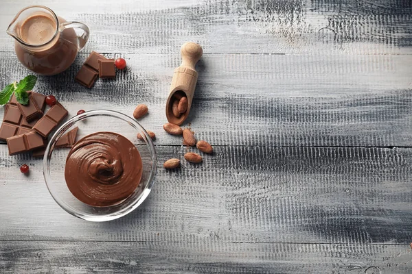 Composition with tasty chocolate on wooden background, top view — Stock Photo, Image