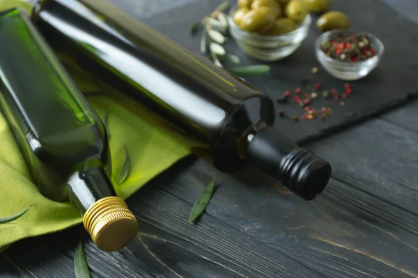 Bottles with olive oil on wooden background — Stock Photo, Image
