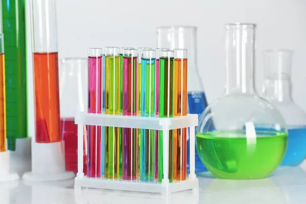 Test tubes with colorful liquids on table — Stock Photo, Image