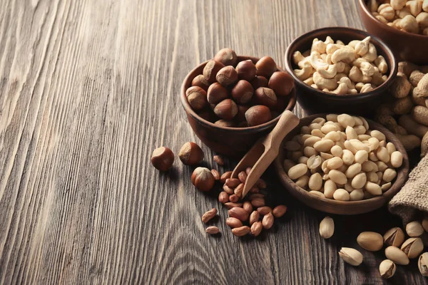 Composition with different nuts on wooden background — Stock Photo, Image