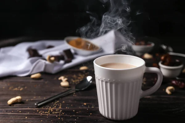 Tasse de thé aromatique avec du lait sur la table — Photo