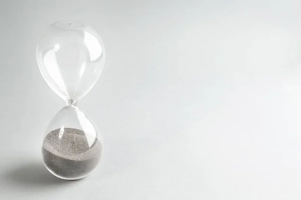 Hourglass on light background. Time management concept — Stock Photo, Image