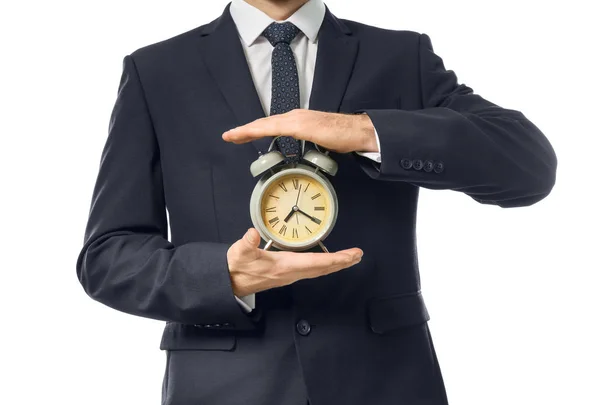 男は白い背景の上の時計を保持しています。時間管理の概念 — ストック写真