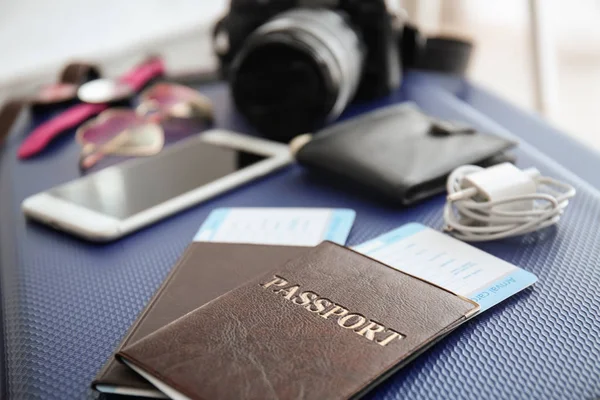 Documents and tourist's stuff on travel suitcase — Stock Photo, Image