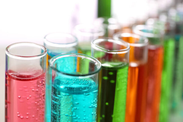 Many test tubes with colorful liquids, closeup