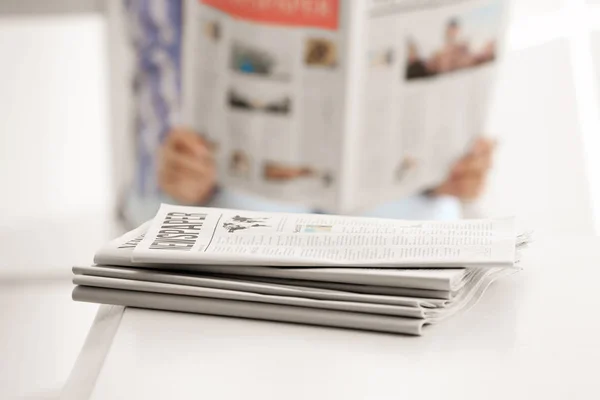 Heap of morning newspapers on white table — Stock Photo, Image