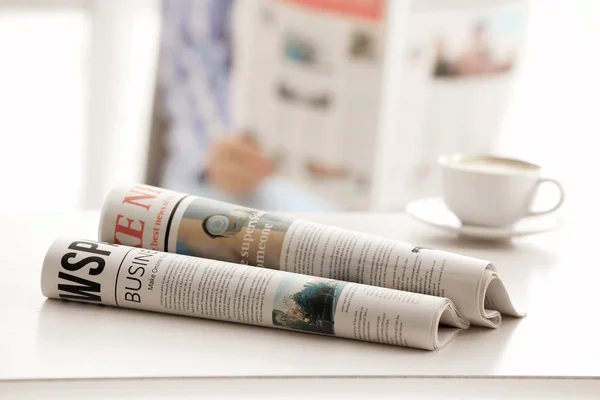 Morning newspapers on white table — Stock Photo, Image