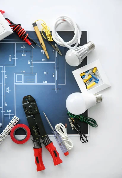 Electrician's supplies with electrical scheme on white background — Stock Photo, Image