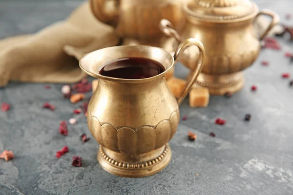 Metal jug of aromatic tea on table — Stock Photo, Image