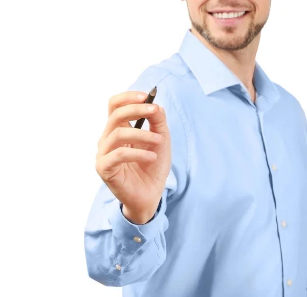 Young businessman writing on virtual screen against white background Stock Photo