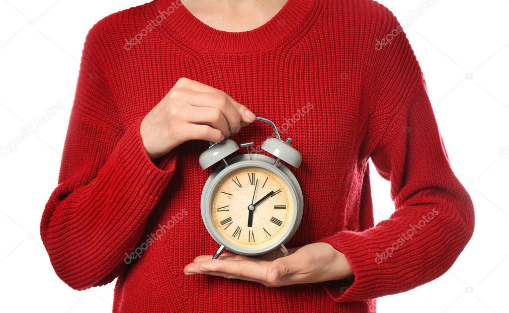 Woman holding alarm clock on white background. Time management concept