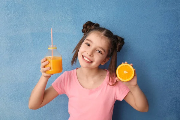 Funny little girl with citrus juice on color background — Stock Photo, Image