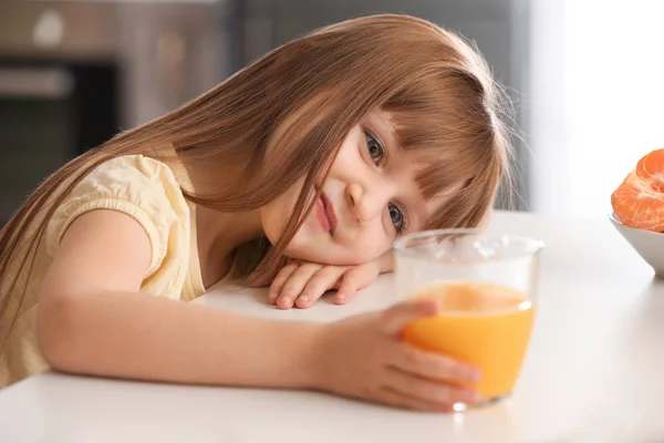 Vicces kis lány a citrusfélék levében otthon — Stock Fotó