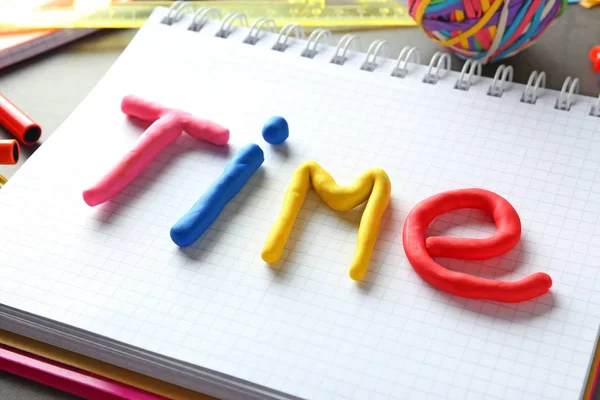 Word TIME made of color plasticine on notebook — Stock Photo, Image