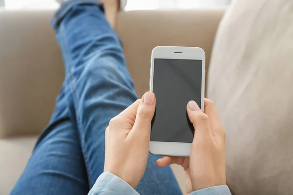 Young woman using mobile phone for online food delivery while resting on sofa indoors — Stock Photo, Image