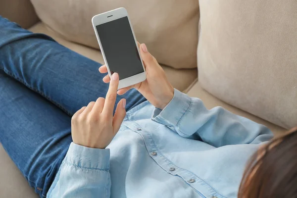 Young woman using mobile phone for online food delivery while resting on sofa indoors — Stock Photo, Image