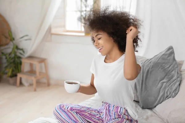 Beautiful African-American woman drinking tea at home — Stock Photo, Image