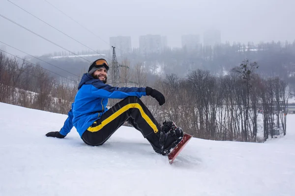 Αρσενικό snowboarder σε πλαγιά στο χειμερινό θέρετρο — Φωτογραφία Αρχείου