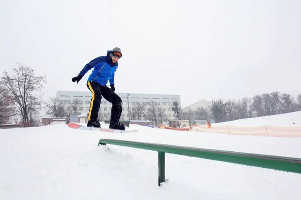 Мужчина сноубордист делает трюк на зимнем курорте — стоковое фото