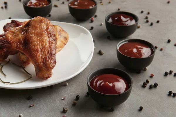 Delicious barbecue sauces in bowls on table