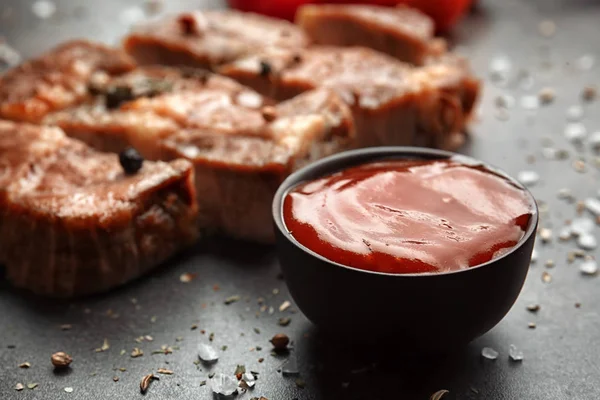 Delicious grilled meat and barbecue sauce on table — Stock Photo, Image