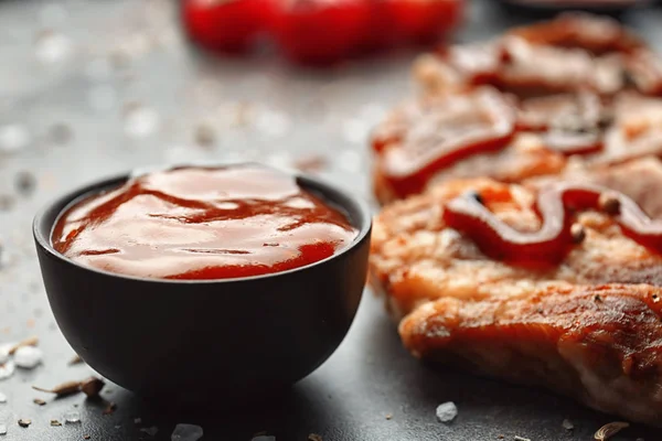 Delicious grilled meat with barbecue sauce on table — Stock Photo, Image