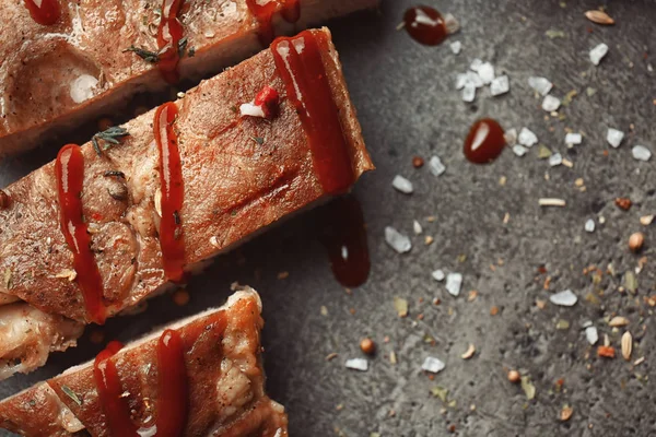 Delicious grilled meat with barbecue sauce on table, top view — Stock Photo, Image