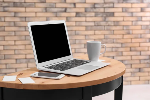 Stijlvolle werkplek met de laptop op tafel — Stockfoto