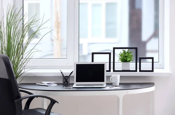 Stylish workplace interior with laptop on table — Stock Photo, Image