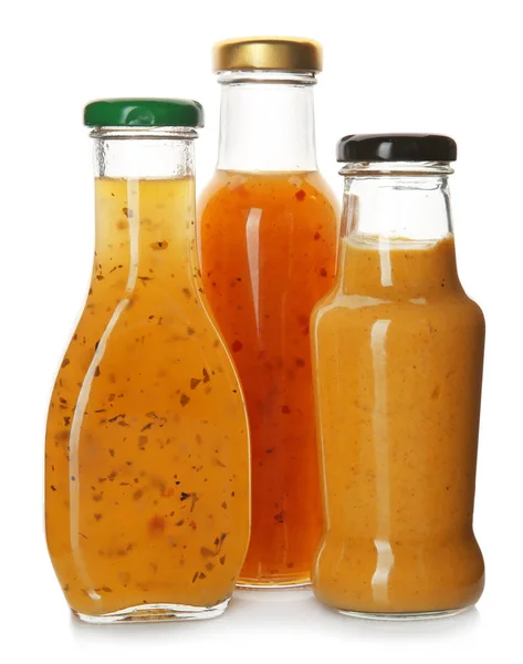 Bottles with tasty sauces on white background — Stock Photo, Image