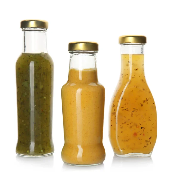 Bouteilles avec de savoureuses sauces sur fond blanc — Photo