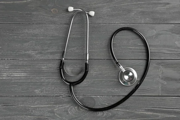 Stethoscope on dark wooden background — Stock Photo, Image