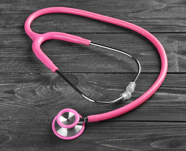 Stethoscope on dark wooden background — Stock Photo, Image