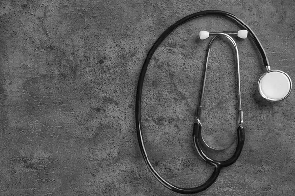 Stethoscope on dark grey background — Stock Photo, Image