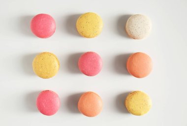 Beyaz zemin üzerine lezzetli renkli macarons