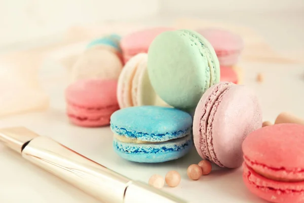 Tasty colorful macarons on light table — Stock Photo, Image