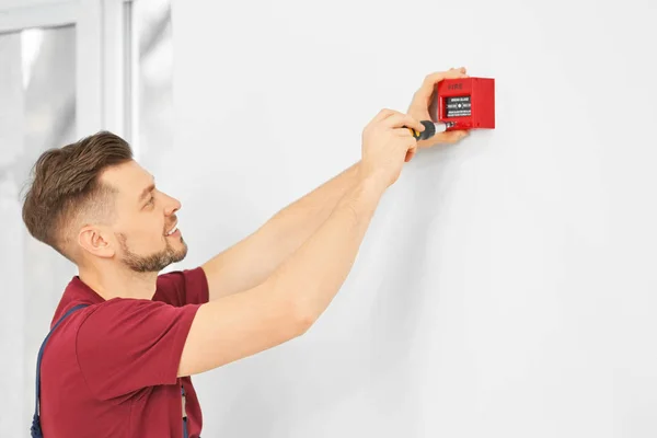 Electrician installing fire alarm system — Stock Photo, Image