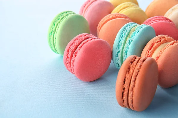 Delicious macarons on color background — Stock Photo, Image