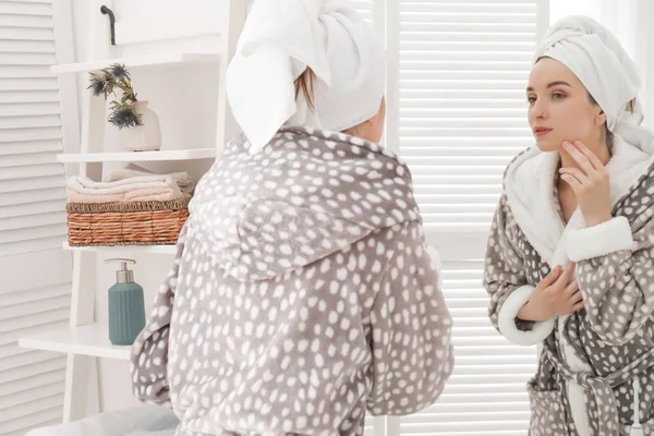 Young woman in bathrobe near mirror at home. Morning routine — Stock Photo, Image