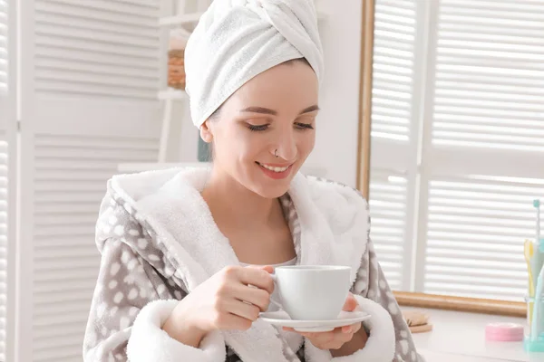 Young woman in bathrobe drinking coffee at home. Early morning — Stock Photo, Image