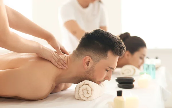 Szczęśliwa para młodych o masażu w spa salon — Zdjęcie stockowe