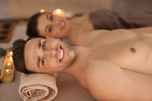 Young man and his girlfriend relaxing in spa salon