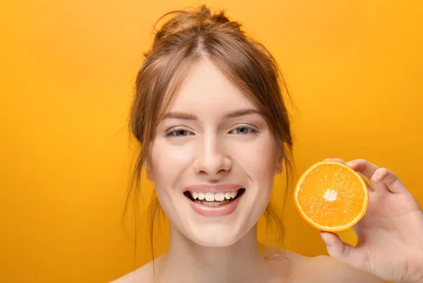 Beautiful young woman with citrus fruit on color background — Stock Photo, Image