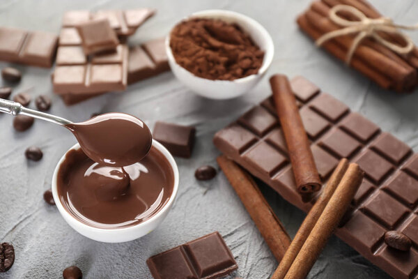 Pouring chocolate into bowl on table