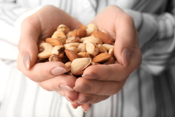 Woman holding many different nuts, closeup