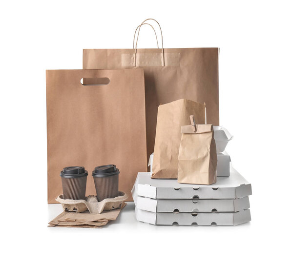 Different types of packages on white background. Food delivery service
