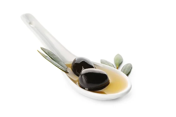 Spoon with black olives and oil on white background — Stock Photo, Image