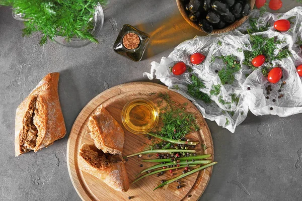 Flat lay composition with olive oil, herbs and bread on table — Stock Photo, Image